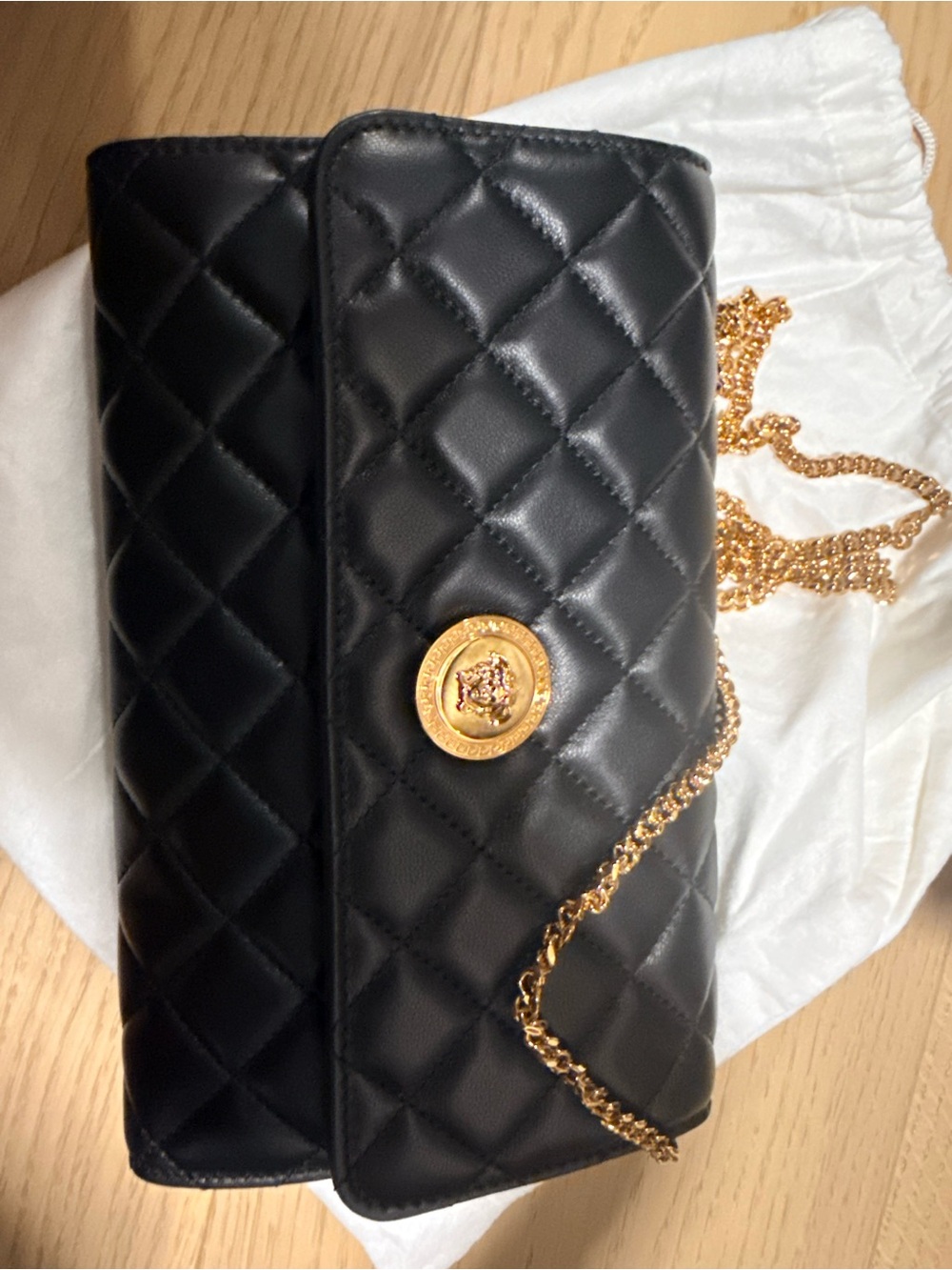 Black Quilted Crossbody Bag with Gold Chain and Medallion
